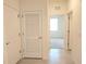 Tiled hallway with access to a bedroom, showcasing the home's layout and design at 6203 Sw 93Rd Loop, Ocala, FL 34476