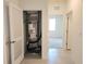 Hallway featuring access to AC unit and an adjacent bedroom offering additional living space at 6203 Sw 93Rd Loop, Ocala, FL 34476