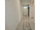 Hallway leading to the front door with neutral walls and tile floor at 6203 Sw 93Rd Loop, Ocala, FL 34476