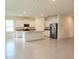 A spacious kitchen featuring white cabinets, granite countertops, an island and stainless steel appliances at 6203 Sw 93Rd Loop, Ocala, FL 34476