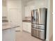 Beautiful kitchen featuring stainless steel refrigerator, granite countertops, and white cabinets at 6203 Sw 93Rd Loop, Ocala, FL 34476