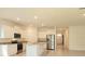 Modern kitchen with stainless steel appliances, white cabinets, granite countertops, and tile flooring at 6203 Sw 93Rd Loop, Ocala, FL 34476