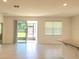 Spacious living room featuring tile flooring, and sliding glass doors leading to the outside at 6203 Sw 93Rd Loop, Ocala, FL 34476