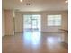 Living room featuring tile floors, sliding glass doors and view of the kitchen at 6203 Sw 93Rd Loop, Ocala, FL 34476