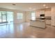 Open-concept living room featuring tile floors, sliding glass doors and kitchen with granite countertops at 6203 Sw 93Rd Loop, Ocala, FL 34476