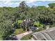 Enjoy this beautiful home's mature landscaping, framed by a canopy of trees, and lush lawn at 621 High Point Dr, Mount Dora, FL 32757