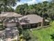 Expansive home showcasing manicured lawns, mature landscaping, and an attached two car garage at 621 High Point Dr, Mount Dora, FL 32757