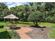 Serene backyard with pond views, a brick patio with seating, and lush greenery offering a peaceful retreat at 621 High Point Dr, Mount Dora, FL 32757