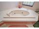 Close-up of a bathtub with stylish fixtures and clean tile work at 621 High Point Dr, Mount Dora, FL 32757