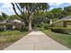 Long driveway surrounded by lush greenery and mature trees leads up to the home, creating a private and serene setting at 621 High Point Dr, Mount Dora, FL 32757