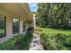 Picture of a lush green lawn, mature trees, and walkway up to the front door at 621 High Point Dr, Mount Dora, FL 32757