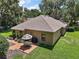 Aerial view of an outdoor patio, perfect for entertaining, adjacent to a lush lawn at 621 High Point Dr, Mount Dora, FL 32757