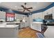 Traditional kitchen with white cabinets, wooden floors, and stainless steel appliances at 621 High Point Dr, Mount Dora, FL 32757