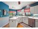 Open kitchen featuring white cabinets, ample countertops, and a view of the breakfast nook at 621 High Point Dr, Mount Dora, FL 32757