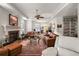 Bright and open living room with a fireplace, comfortable seating, and built-in shelving, creating a welcoming space at 621 High Point Dr, Mount Dora, FL 32757