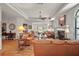 Large living room featuring a fireplace, hardwood floors, and elegant furnishings, ideal for relaxation and social events at 621 High Point Dr, Mount Dora, FL 32757