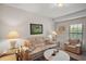 Bright living room with comfortable seating, artwork, and ample natural light at 621 High Point Dr, Mount Dora, FL 32757