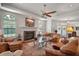 Expansive living room with fireplace, ceiling fan, and plentiful seating, offering a warm and inviting atmosphere at 621 High Point Dr, Mount Dora, FL 32757