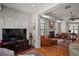 Open living room featuring hardwood flooring, fireplace, and an adjoining living space at 621 High Point Dr, Mount Dora, FL 32757