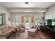 Bright living room featuring neutral paint, recessed lights, and a comfy seating arrangement at 621 High Point Dr, Mount Dora, FL 32757
