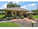 Outdoor brick patio featuring a table, chairs, and grill, perfect for outdoor dining and entertaining at 621 High Point Dr, Mount Dora, FL 32757