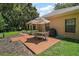 Outdoor brick patio with seating and a grill provides a perfect space for outdoor relaxation and entertaining at 621 High Point Dr, Mount Dora, FL 32757