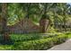 Community entrance sign amidst lush greenery, welcoming residents to the High Point neighborhood at 621 High Point Dr, Mount Dora, FL 32757