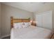 Cozy bedroom with decorative pillows and a soft, light-colored striped bedspread at 6243 Danielson Loop, The Villages, FL 32163