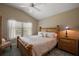 Bedroom featuring a bed with decorative pillows, a bamboo-style nightstand and ample natural light at 6243 Danielson Loop, The Villages, FL 32163