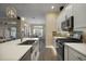 Bright kitchen with stainless steel appliances, quartz countertops, subway tile backsplash, and view into dining area at 6243 Danielson Loop, The Villages, FL 32163