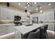 Bright kitchen featuring stainless steel appliances, quartz countertops, and a large center island with counter seating at 6243 Danielson Loop, The Villages, FL 32163