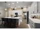 Bright kitchen with stainless steel appliances, quartz countertops, island seating, and modern pendant lighting at 6243 Danielson Loop, The Villages, FL 32163