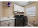 Well-organized laundry room featuring modern appliances and ample storage at 6243 Danielson Loop, The Villages, FL 32163