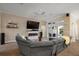 Cozy living room with fireplace and view to backyard. Comfortable sectional sofa and neutral tones at 6243 Danielson Loop, The Villages, FL 32163