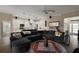 Spacious open floor plan with view into kitchen; features a large sectional sofa and patterned rug at 6243 Danielson Loop, The Villages, FL 32163