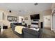 Cozy living room featuring a plush gray sectional sofa and a modern electric fireplace below a wall-mounted TV at 6243 Danielson Loop, The Villages, FL 32163