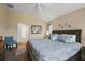 Comfortable main bedroom showcasing a king-sized bed and neutral décor with ample natural light from multiple windows at 6243 Danielson Loop, The Villages, FL 32163