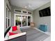 Comfortable seating area on an enclosed patio with ceiling fans and open access to backyard at 6243 Danielson Loop, The Villages, FL 32163