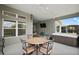 Enclosed patio boasts an outdoor dining set, ceiling fans, and backyard views at 6243 Danielson Loop, The Villages, FL 32163