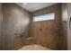 Modern tiled shower with a built-in seat, a window and sleek fixtures at 6243 Danielson Loop, The Villages, FL 32163