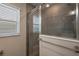 Contemporary bathroom showcasing a glass-enclosed shower with modern gray tiling at 6243 Danielson Loop, The Villages, FL 32163