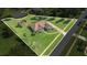 Expansive property featuring a well-maintained lawn, fenced backyard with a firepit, and a charming single-story home at 7629 Lake Angelina Dr, Mount Dora, FL 32757