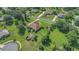 Sprawling lot showcasing the home's mature landscaping, fenced backyard, and outdoor entertaining area at 7629 Lake Angelina Dr, Mount Dora, FL 32757