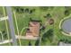 Expansive aerial view of the home's roofline, mature trees, backyard, and outdoor living space at 7629 Lake Angelina Dr, Mount Dora, FL 32757