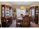 Elegant dining room featuring wooden furniture and decorative chandelier at 7629 Lake Angelina Dr, Mount Dora, FL 32757