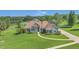 A charming home features manicured landscaping, a lush green lawn, and stone accents around the windows at 7629 Lake Angelina Dr, Mount Dora, FL 32757