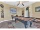Game room with billiard table, ceiling fan, and artwork at 7629 Lake Angelina Dr, Mount Dora, FL 32757