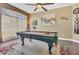 Game room with billiard table, ceiling fan, and natural light at 7629 Lake Angelina Dr, Mount Dora, FL 32757