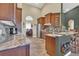 Modern kitchen with stainless steel appliances, wood cabinets, and marble countertops at 7629 Lake Angelina Dr, Mount Dora, FL 32757