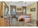 Spacious main bedroom with wood floors, a ceiling fan, and multiple windows at 7629 Lake Angelina Dr, Mount Dora, FL 32757